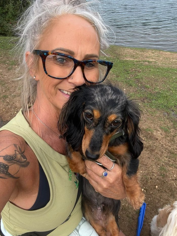 Sandra and a dachshund pal enjoying a lakeside walk